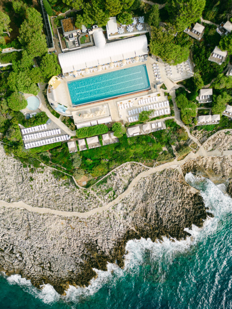 Serene coastline of Saint-Jean-Cap-Ferrat, an idyllic location for a French Riviera engagement getaway, with clear waters and Mediterranean flora