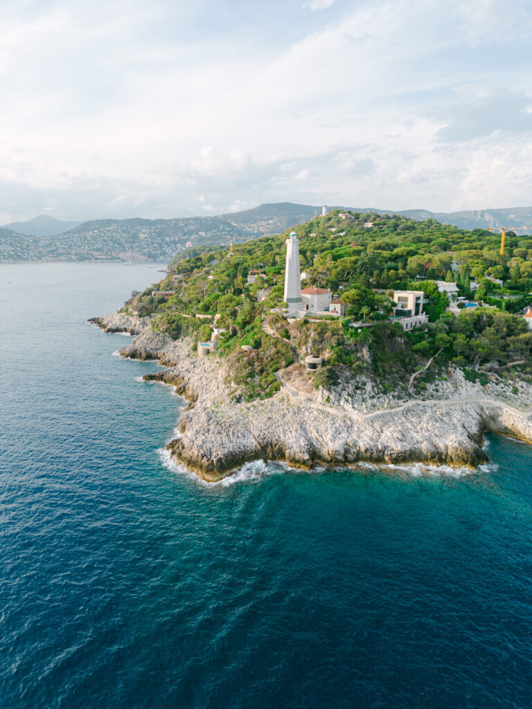 Serene coastline of Saint-Jean-Cap-Ferrat, an idyllic location for a French Riviera engagement getaway, with clear waters and Mediterranean flora