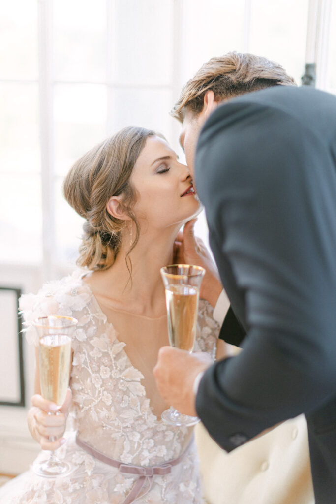Chateau Mader wedding toast: couple's joyous champagne clink