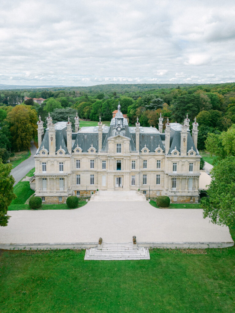 The aerial perspective of Château de St Martin du Tertre reveals its harmonious integration with nature, a top choice among luxury wedding châteaux near Paris