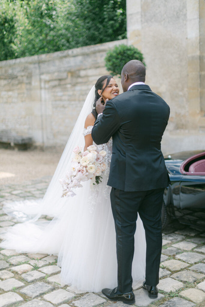 The first look, set against the backdrop of Chateau de Villette's grandeur, captures a timeless moment of love and anticipation, befitting their Parisian wedding elegance