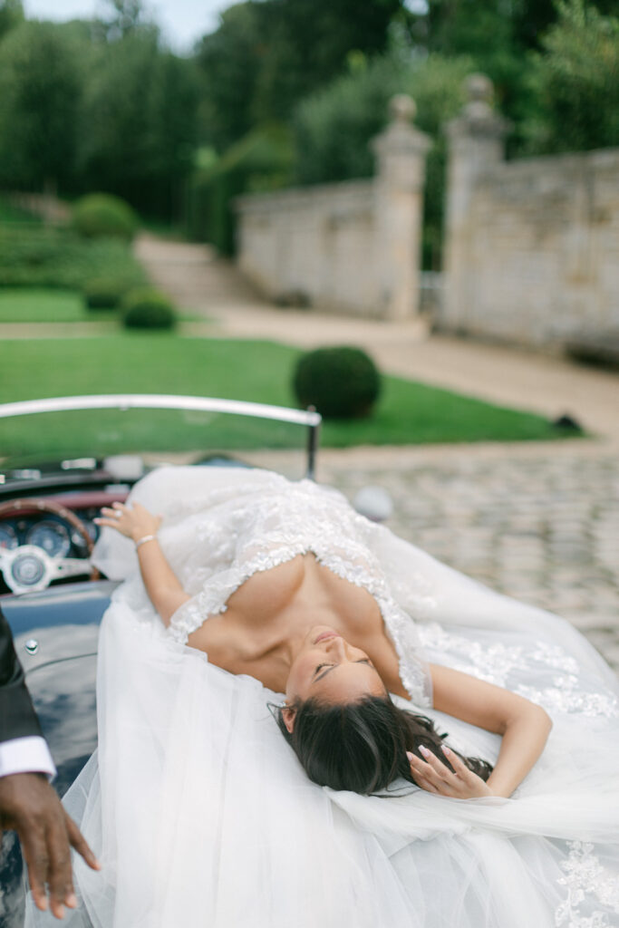 In the enchanting gardens of Chateau de Villette, their first look unfolds, a moment of pure emotion, marking the beginning of their elegant Parisian wedding journey