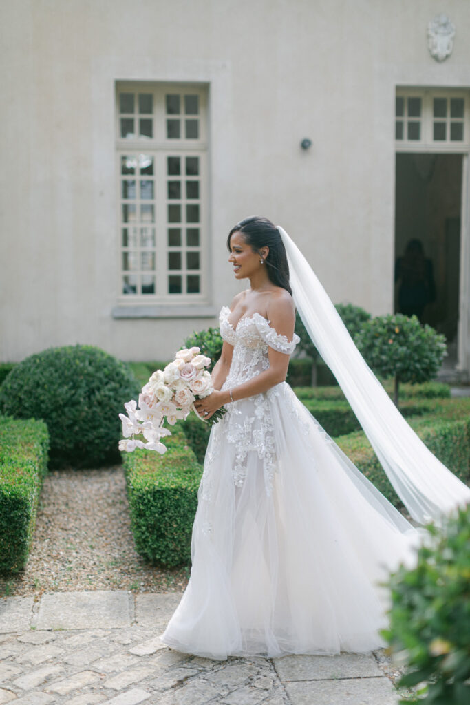 Beneath the age-old trees of Chateau de Villette, their eyes meet for the first time on their wedding day, igniting the magic of their Parisian love story