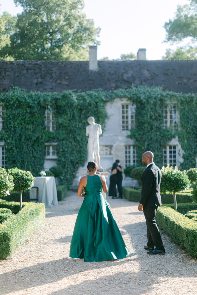 Guests mingle in the lush gardens of Chateau de Villette, sipping on exquisite cocktails, as the Parisian evening air buzzes with celebration