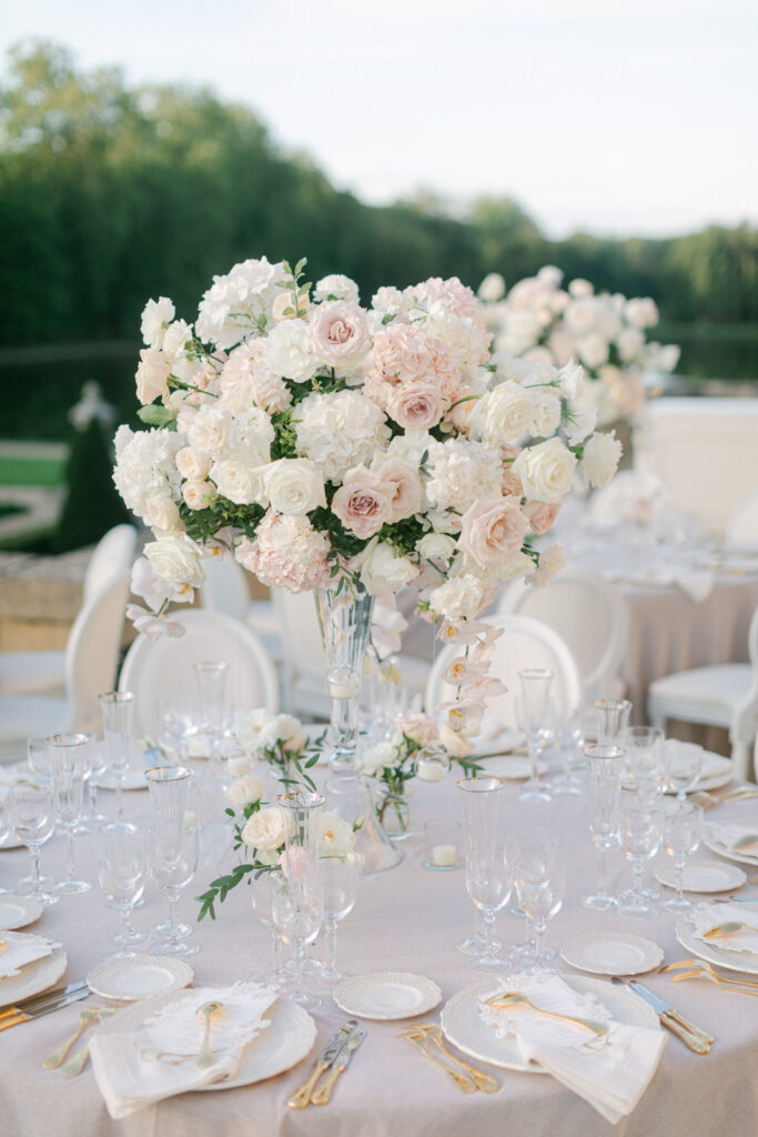 The tablescapes at 'Chateau de Villette: An Elegant Parisian Wedding' exude sophistication, with floral arrangements and fine china that echo the chateau's luxurious ambiance