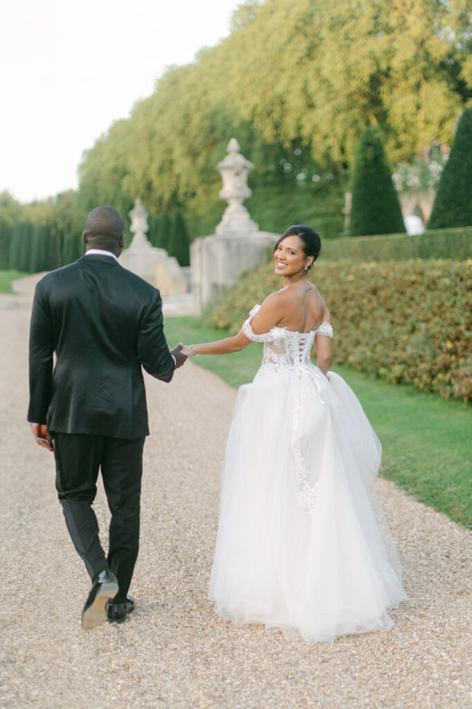 Amidst the verdant gardens of Chateau de Villette, the couple's photos radiate the essence of 'Chateau de Villette: An Elegant Parisian Wedding,' a celebration of romance and elegance.