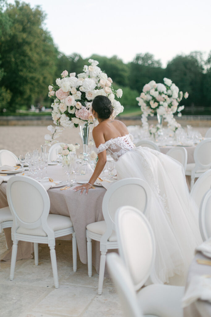 Under the chandeliers of Chateau de Villette, the tables are set in a style befitting 'Chateau de Villette: An Elegant Parisian Wedding,' showcasing exquisite taste and attention to detail
