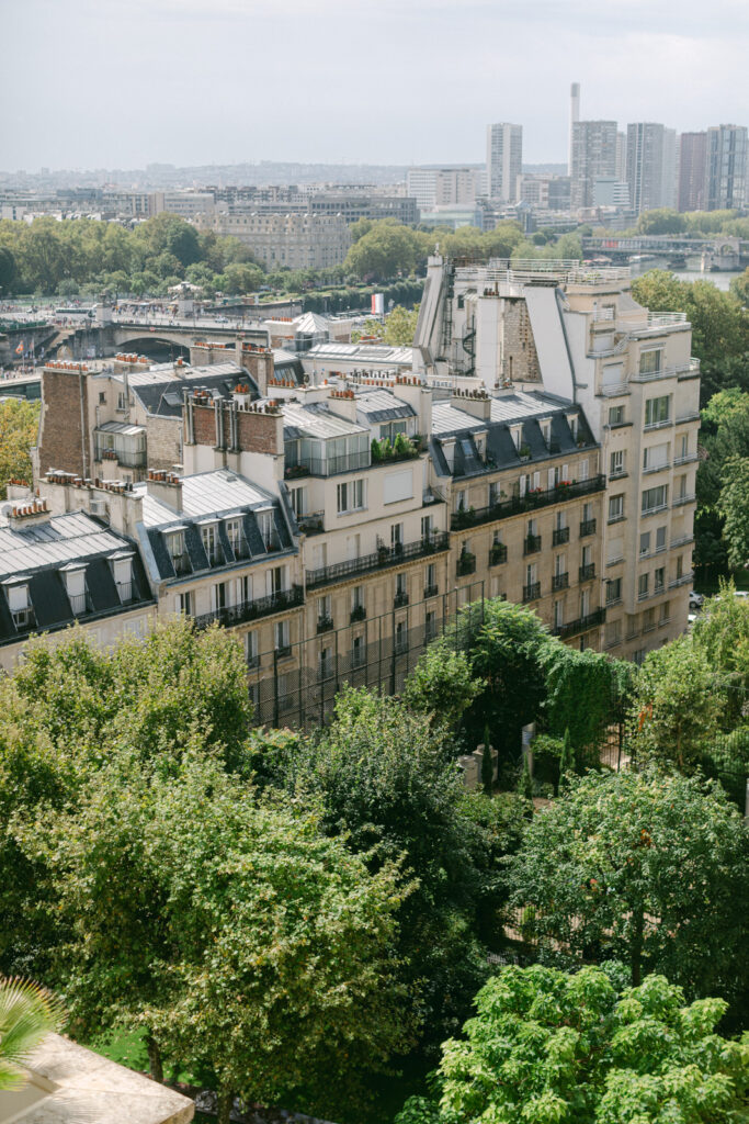 Gazing out from a George V suite, the sprawling Parisian cityscape whispers promises of the upcoming elegance at 'Chateau de Villette: An Elegant Parisian Wedding