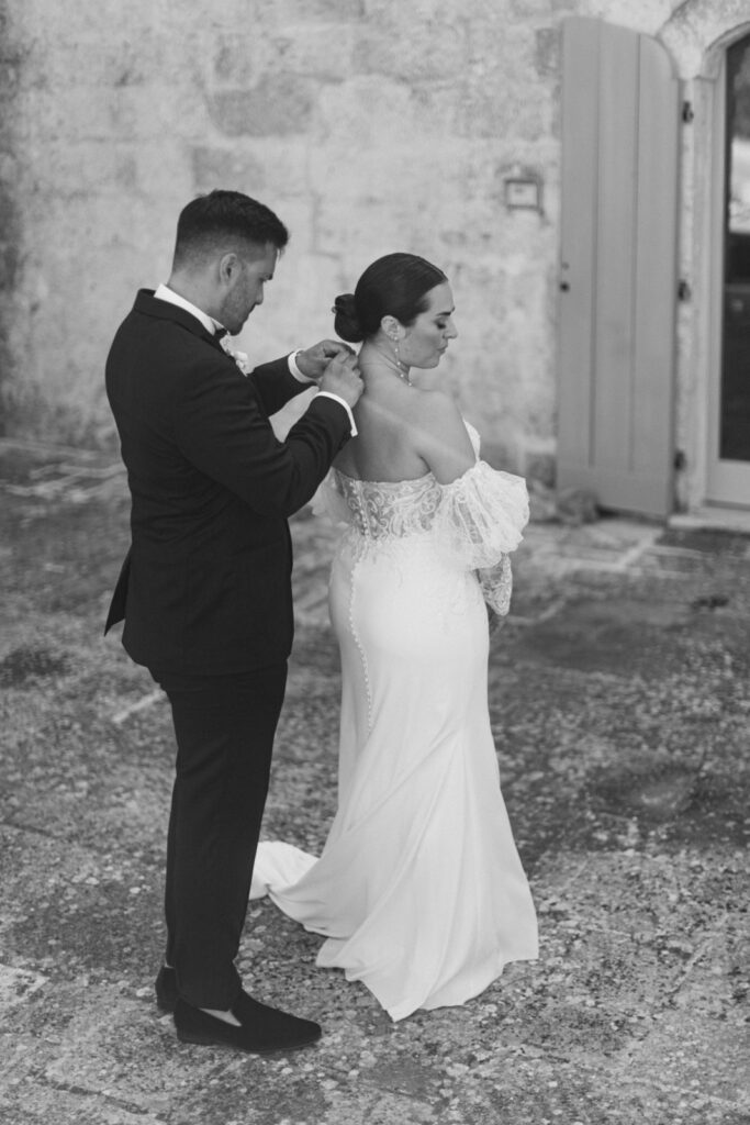 The air of a Puglian wedding affair is thick with anticipation as the bride gently taps the groom's shoulder, their first look about to weave their souls together.