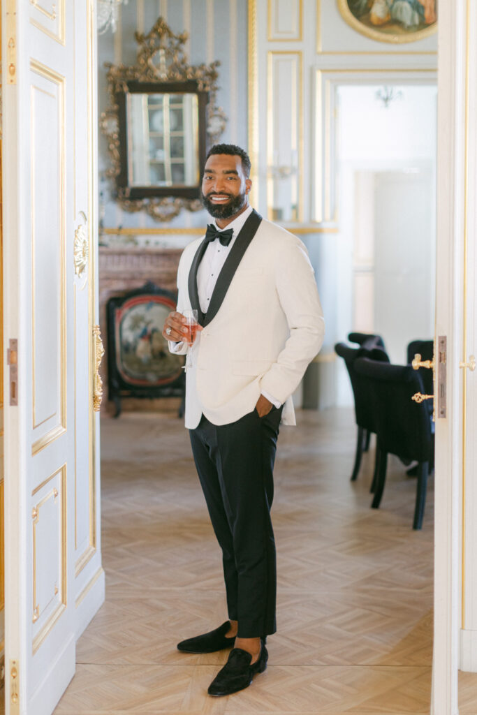 In the refined setting of Château Saint-Georges, the groom and his groomsmen share a moment of camaraderie, preparing for the day with a mix of excitement and solemnity