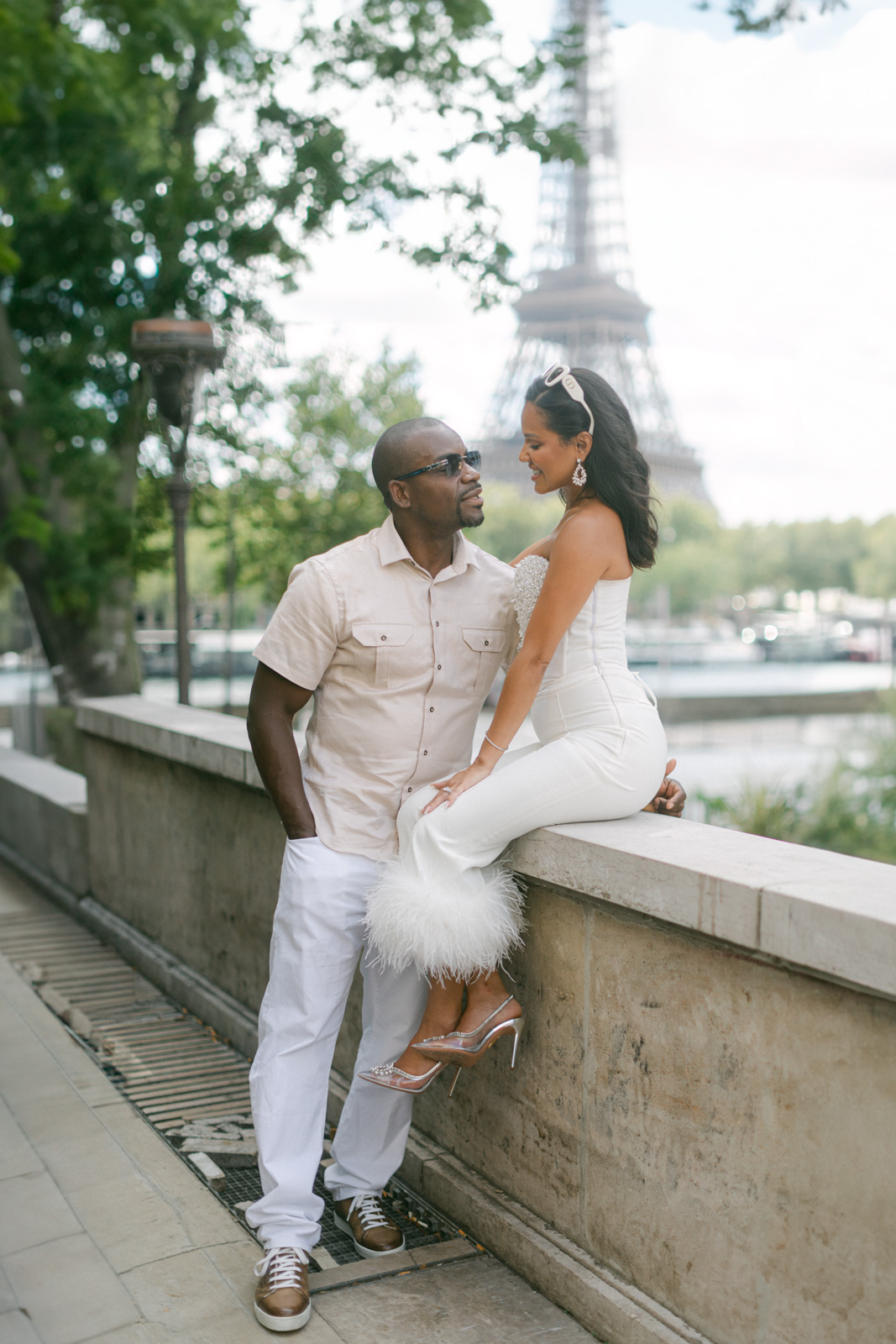 Captured in the glow of the setting sun, a couple shares a tender moment during their engagement session Trocadéro, with the Eiffel Tower lending its grandeur to their love story.