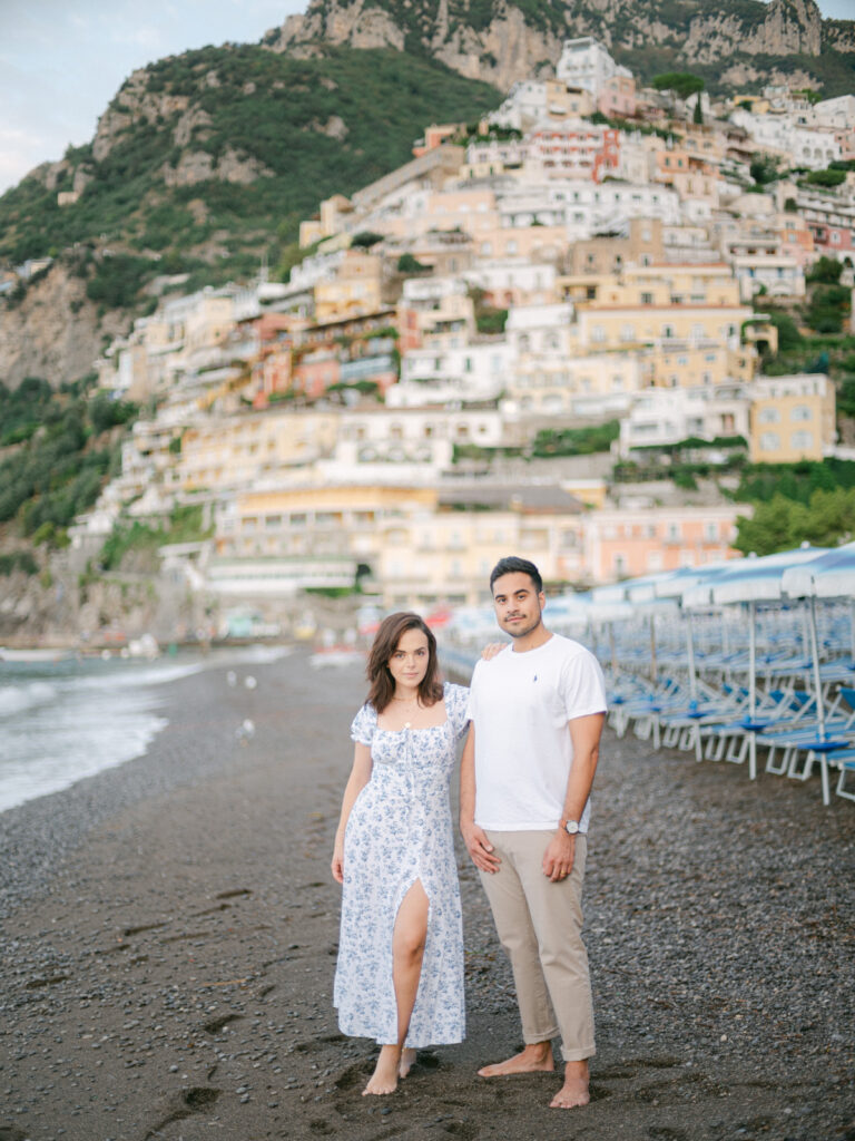 Capturing the magic of their honeymoon in Positano, the couple enjoys a quiet moment by the turquoise waters of the Amalfi Coast.