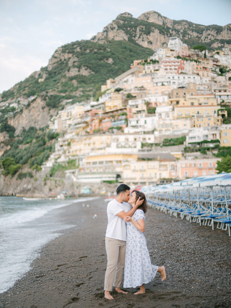 Capturing the magic of their honeymoon in Positano, the couple enjoys a quiet moment by the turquoise waters of the Amalfi Coast.