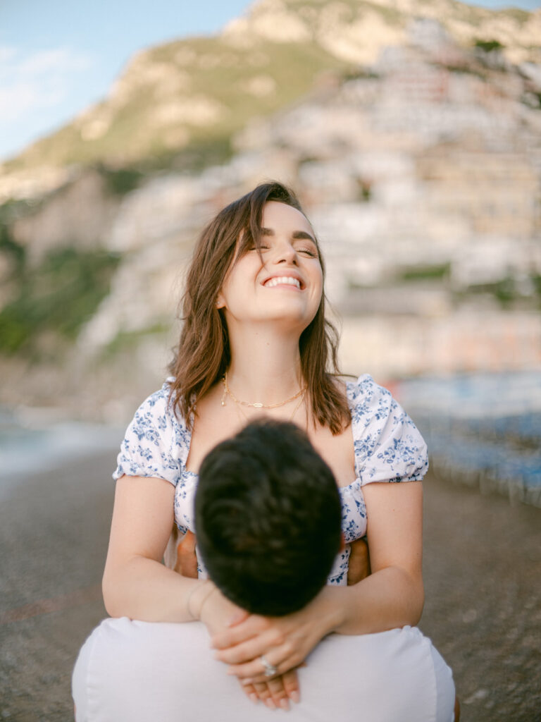 Celebrating their love on the Amalfi Coast, the couple gazes out at the sea, creating unforgettable memories during their honeymoon in Positano.
