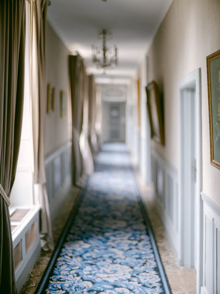 Sunlight pouring through the château windows, stillness in the air. A perfect beginning to this Château d’Aveny wedding near Paris.