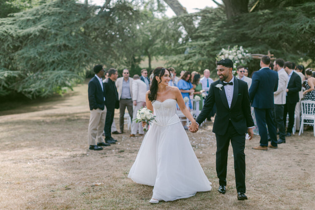 outdoor ceremony under trees at Château de Seguin wedding