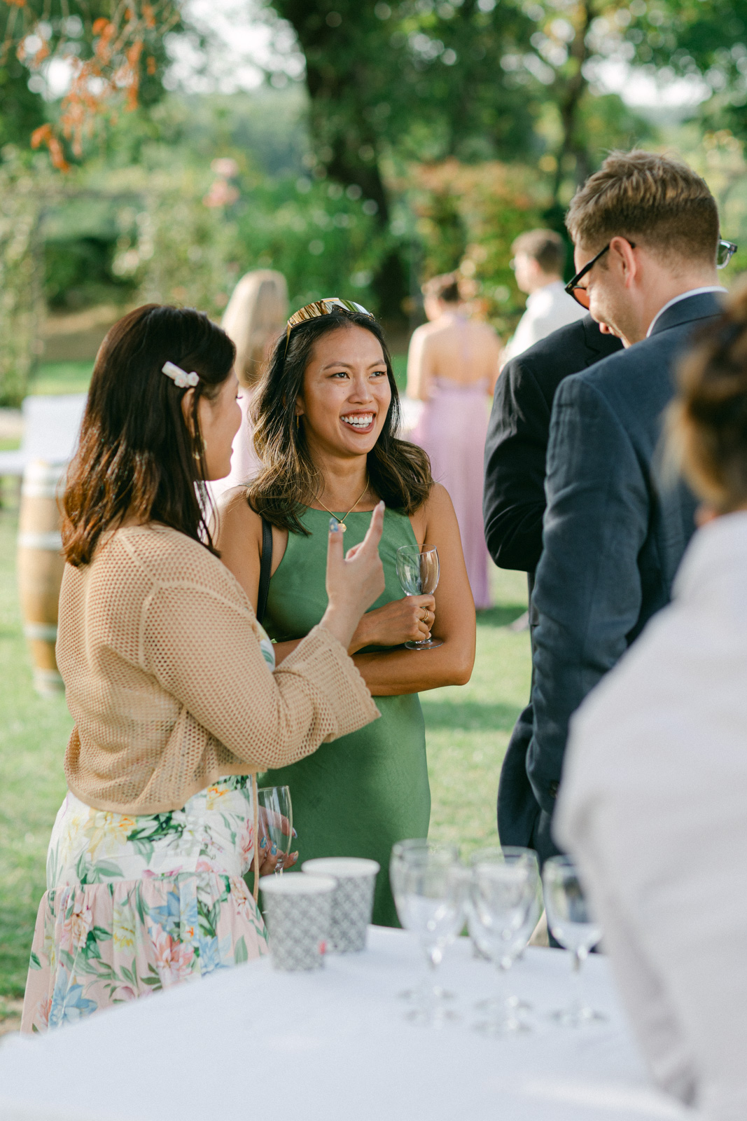 Guests enjoying cocktail hour in the gardens of Château de Seguin wedding in Bordeaux