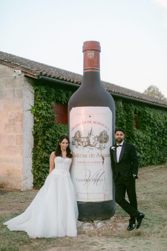 bride and groom walking through vineyard at Chateau de Seguin