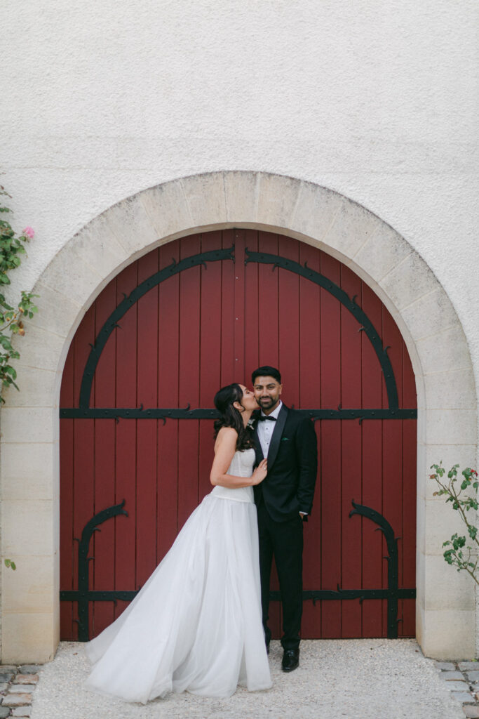 bride and groom walking through vineyard at Chateau de Seguin