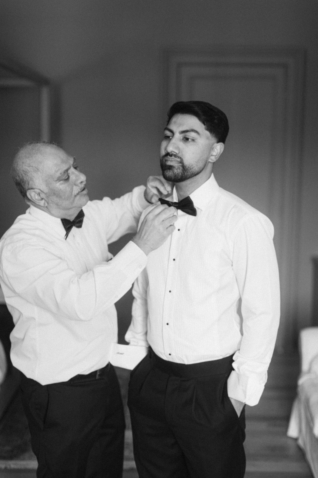 Groom adjusting cufflinks before ceremony at Château de Seguin