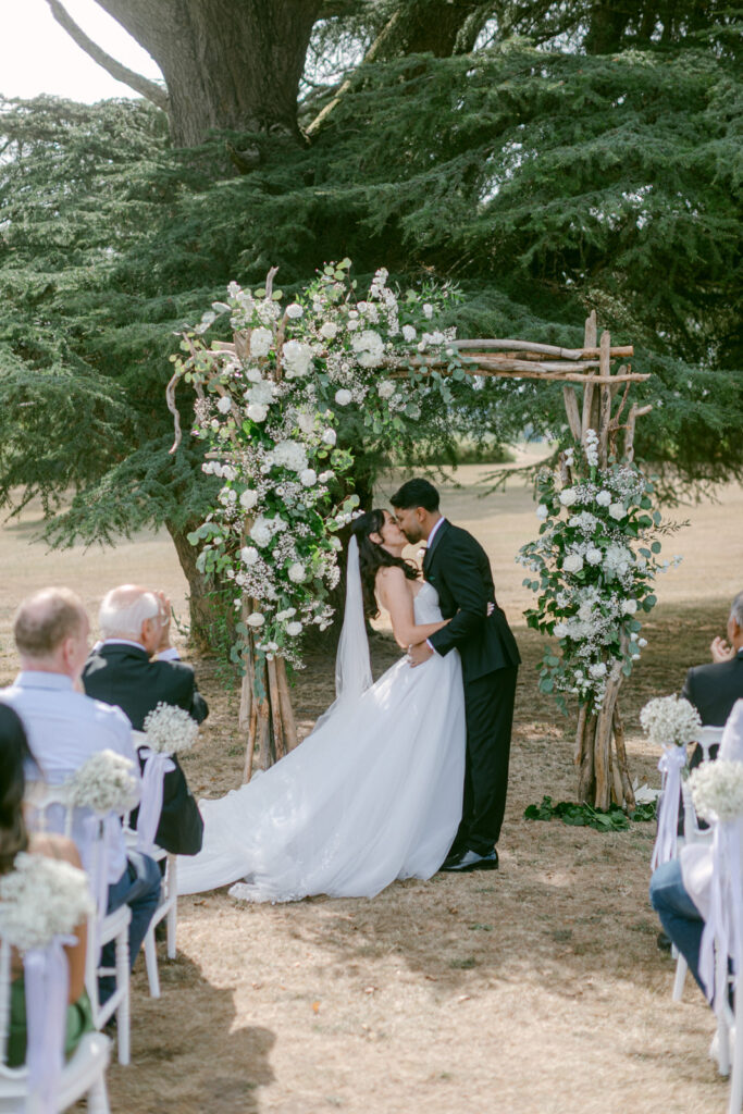 outdoor ceremony under trees at Château de Seguin