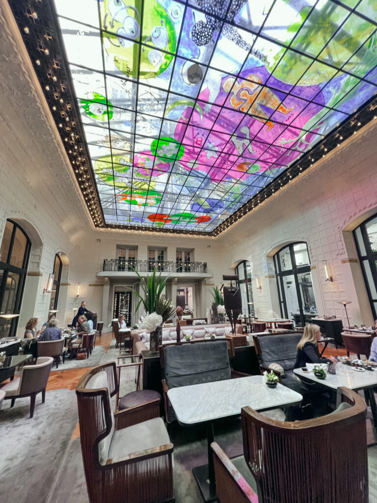 Contemporary dining room with artistic glass ceiling at a Paris luxury palace hotel Le Lutetia