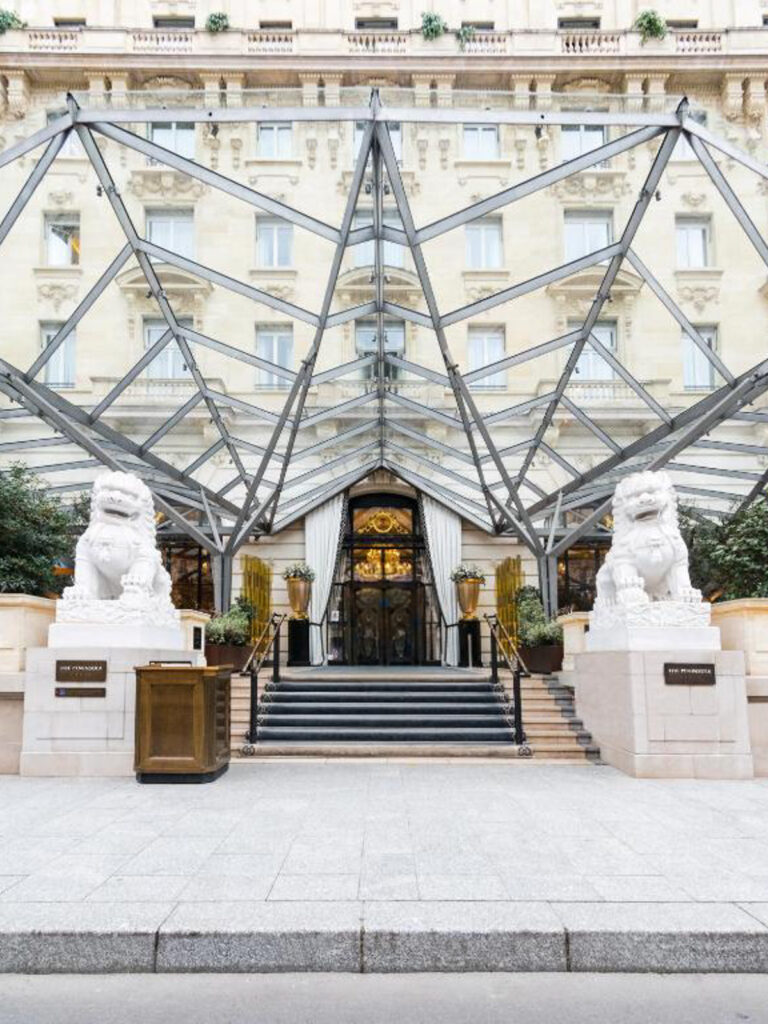 Entrance of The Peninsula Paris with iconic lion statues, luxury palace wedding venue